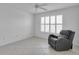 Bright bedroom with neutral walls and floors and a large sunny window at 1819 Captiva Ct, The Villages, FL 32162
