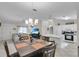 Open floor plan shows living room, dining area, and kitchen with natural light and bar seating at 1819 Captiva Ct, The Villages, FL 32162