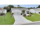 Lovely single-story home showcases a manicured lawn and thoughtfully arranged landscaping at 1819 Captiva Ct, The Villages, FL 32162