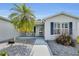 Cozy front porch with seating area, complemented by neat landscaping and inviting entrance at 1819 Captiva Ct, The Villages, FL 32162
