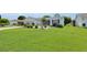 Beautifully landscaped front yard with fresh green lawn and flowering plants at 1819 Captiva Ct, The Villages, FL 32162