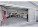 Spacious garage with insulated garage door and well-organized storage at 1819 Captiva Ct, The Villages, FL 32162