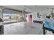 Spacious garage with an epoxy floor and insulated garage door at 1819 Captiva Ct, The Villages, FL 32162