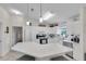 Bright kitchen features white cabinets, stainless steel appliances, and a large island with seating at 1819 Captiva Ct, The Villages, FL 32162
