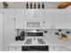 Well-equipped kitchen featuring modern appliances, white cabinets, and blue accent backsplash at 1819 Captiva Ct, The Villages, FL 32162