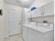 Bright laundry room with white cabinets and modern washer and dryer at 1819 Captiva Ct, The Villages, FL 32162