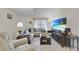 Comfortable living room with cozy sectional couch, perfect for relaxing and watching television at 1819 Captiva Ct, The Villages, FL 32162