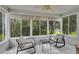 Cozy sunroom with large windows offering relaxing outdoor views at 1819 Captiva Ct, The Villages, FL 32162