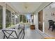 Bright sunroom with chairs and sliding door to the dining area at 1819 Captiva Ct, The Villages, FL 32162