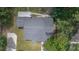 Overhead shot of the roof and backyard featuring a wooden deck area, surrounded by green grass and mature trees at 1831 Sw 5Th Ave, Ocala, FL 34471