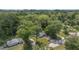 Aerial view of the property nestled among mature trees, showcasing a home with a generous yard and quiet neighborhood at 1831 Sw 5Th Ave, Ocala, FL 34471