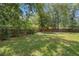 Spacious backyard featuring lush greenery and a wooden privacy fence at 1831 Sw 5Th Ave, Ocala, FL 34471