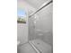 Bathroom boasts a tiled shower and glass doors with a window and toilet at 1831 Sw 5Th Ave, Ocala, FL 34471