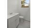 Bathroom featuring white vanity with cabinet and standard toilet next to a window at 1831 Sw 5Th Ave, Ocala, FL 34471