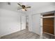 Bedroom with modern flooring, a ceiling fan, closet, and interior door at 1831 Sw 5Th Ave, Ocala, FL 34471
