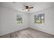 Bright bedroom with a ceiling fan, two windows, and new laminate flooring at 1831 Sw 5Th Ave, Ocala, FL 34471