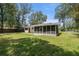 Charming single-story home with a large lawn, mature trees, and a screened patio at 1831 Sw 5Th Ave, Ocala, FL 34471