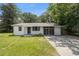 Ranch-style home with a concrete driveway, tidy landscaping, and classic architectural details at 1831 Sw 5Th Ave, Ocala, FL 34471
