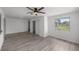 Bright living room with hardwood floors, closet, and large window overlooking yard at 1831 Sw 5Th Ave, Ocala, FL 34471