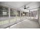 Bright sunroom with tile floors, ceiling fan, and many windows overlooking the yard at 1831 Sw 5Th Ave, Ocala, FL 34471