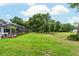 Lush backyard features a screened patio and lush grass, providing a serene outdoor space at 19115 Sw 98Th Loop, Dunnellon, FL 34432