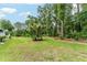 Spacious backyard with green grass and shade trees, ideal for outdoor enjoyment at 19115 Sw 98Th Loop, Dunnellon, FL 34432
