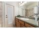 Bathroom featuring a sink and countertop, shower/tub combo, and door to exterior at 19115 Sw 98Th Loop, Dunnellon, FL 34432