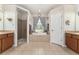 Spacious bathroom featuring double sinks, walk-in shower, and large garden tub under a window at 19115 Sw 98Th Loop, Dunnellon, FL 34432
