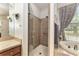 Bathroom featuring a glass-enclosed shower, vanity with mirror, and soaking tub at 19115 Sw 98Th Loop, Dunnellon, FL 34432
