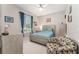Comfortable bedroom with a ceiling fan, natural light and patterned chair at 19115 Sw 98Th Loop, Dunnellon, FL 34432