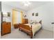 Bright bedroom with natural light, dresser, nightstand, and a wooden bed at 19115 Sw 98Th Loop, Dunnellon, FL 34432