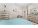 Spacious bedroom features a connecting doorway to the bathroom and a patterned chair at 19115 Sw 98Th Loop, Dunnellon, FL 34432