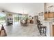 Bright dining area flows to lanai with pool view, light floors, and bar seating at 19115 Sw 98Th Loop, Dunnellon, FL 34432
