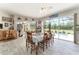Dining room showcasing screened in pool views and wood dining table that seats six at 19115 Sw 98Th Loop, Dunnellon, FL 34432