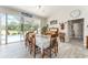 Dining room featuring wood table and chairs, pool views, and sliding door access to screened patio at 19115 Sw 98Th Loop, Dunnellon, FL 34432