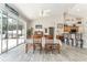 Dining room showcasing sliding glass door access to screened patio and view of pool at 19115 Sw 98Th Loop, Dunnellon, FL 34432