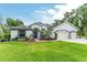 Charming one-story home with well-manicured lawn, inviting entryway, and convenient three-car garage at 19115 Sw 98Th Loop, Dunnellon, FL 34432