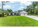 Beautifully landscaped front yard with lush green lawn and charming curb appeal at 19115 Sw 98Th Loop, Dunnellon, FL 34432