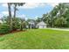 Inviting single-Gathering home with a lush front lawn and mature trees, showcasing curb appeal at 19115 Sw 98Th Loop, Dunnellon, FL 34432
