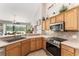 Bright kitchen with stainless appliances and light wood cabinets overlooks dining area at 19115 Sw 98Th Loop, Dunnellon, FL 34432