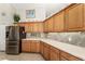 Kitchen with stainless steel fridge, bright cabinets, and granite countertops at 19115 Sw 98Th Loop, Dunnellon, FL 34432