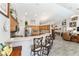 Open kitchen with bar seating overlooks the living area and bright wood cabinets at 19115 Sw 98Th Loop, Dunnellon, FL 34432