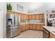 Bright kitchen with stainless steel fridge, bright cabinets, and granite countertops at 19115 Sw 98Th Loop, Dunnellon, FL 34432