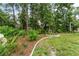 Beautifully landscaped backyard with decorative stone borders and mulched garden beds with shrubs and green plants at 19115 Sw 98Th Loop, Dunnellon, FL 34432