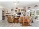Living room showcasing art, vaulted ceilings, wood-look flooring, and access to outdoor spaces at 19115 Sw 98Th Loop, Dunnellon, FL 34432