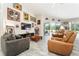 Inviting living room with tile floors, plenty of seating, and a view of the pool and backyard at 19115 Sw 98Th Loop, Dunnellon, FL 34432