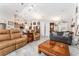 Open living room featuring neutral decor, wood-look flooring, and lots of natural light at 19115 Sw 98Th Loop, Dunnellon, FL 34432