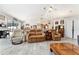 Open living room with wood-look flooring, vaulted ceilings, and plenty of space to relax at 19115 Sw 98Th Loop, Dunnellon, FL 34432