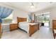 Spacious main bedroom featuring wood furniture, and a serene view of the screened patio at 19115 Sw 98Th Loop, Dunnellon, FL 34432