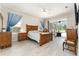 Spacious main bedroom with wood furniture, and a tranquil view of the screened patio at 19115 Sw 98Th Loop, Dunnellon, FL 34432